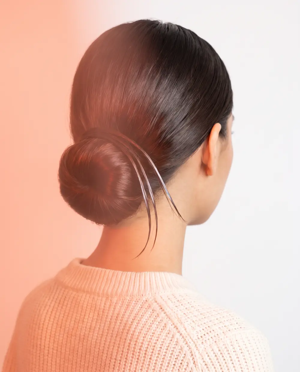 A sleek, glossy low bun
